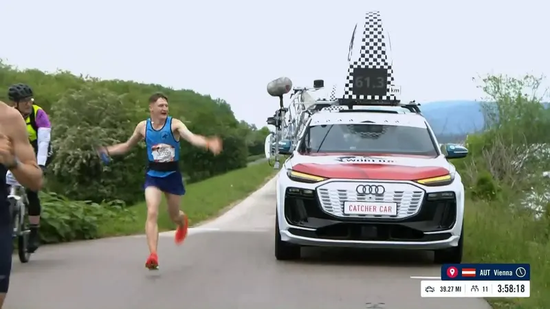 Krzysztof Sokół biegnie przed samochodem pościgowym podczas Wings for Life World Run w Wiedniu